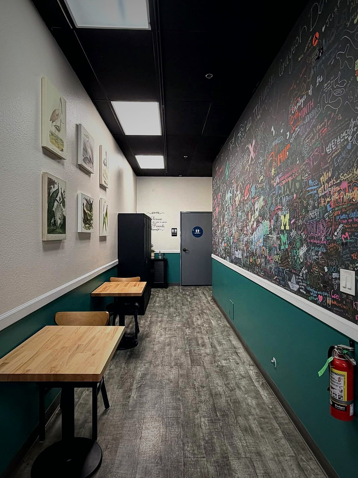 T4 Folsom chalk wall hallway with customer art and bird prints